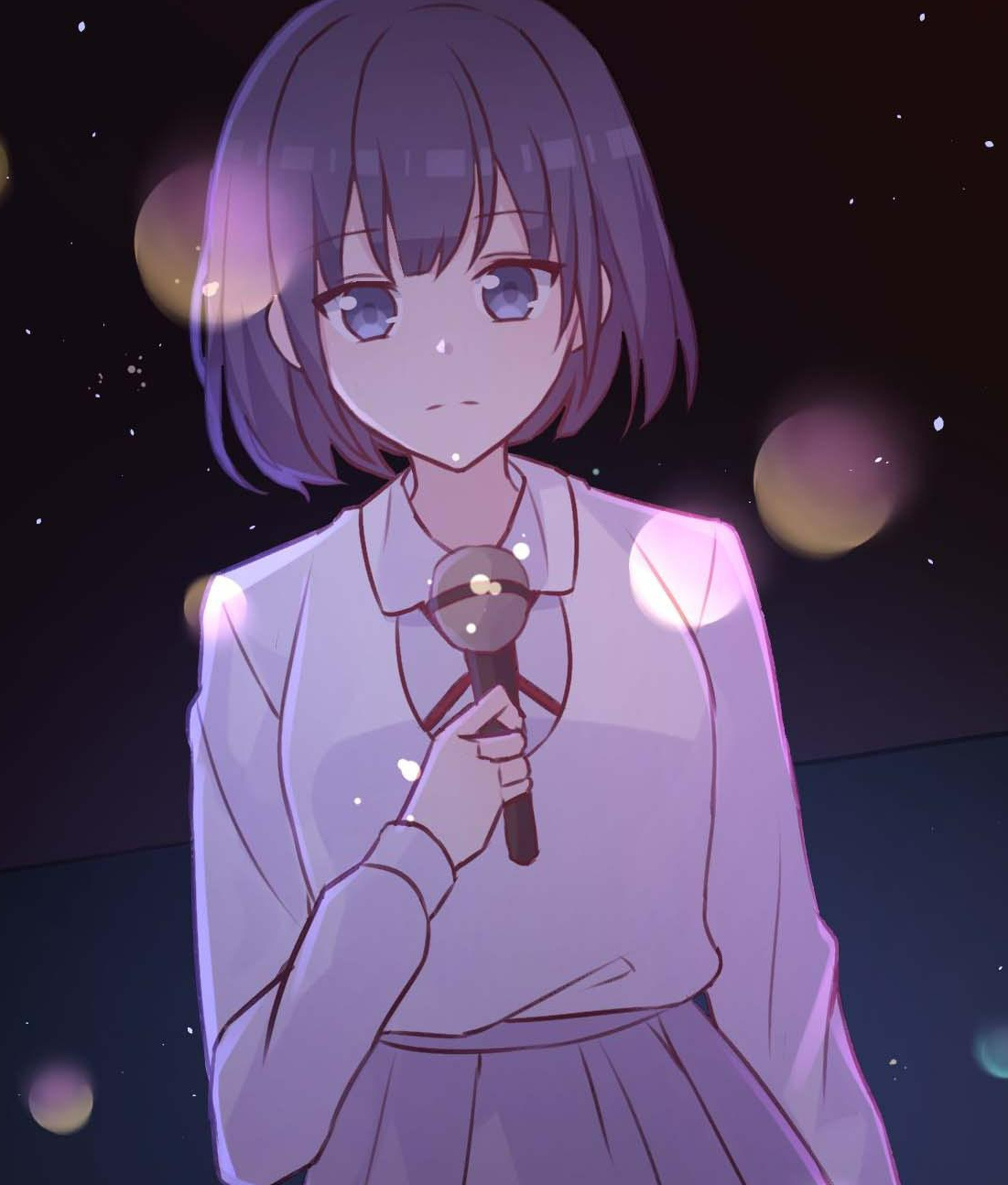 Gu An holding a microphone under stage lights