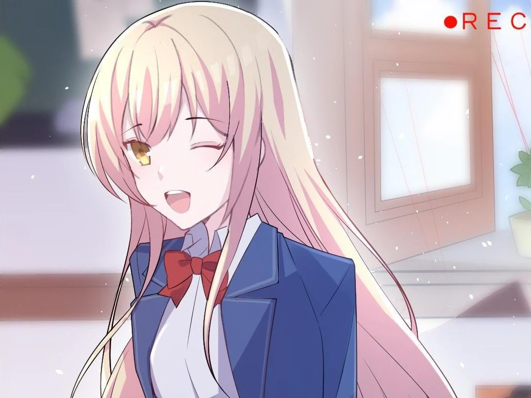 Xinghuo leans on a desk and winks inside the camera’s REC frame, Ch. 3 of Seeing Xinghuo Again