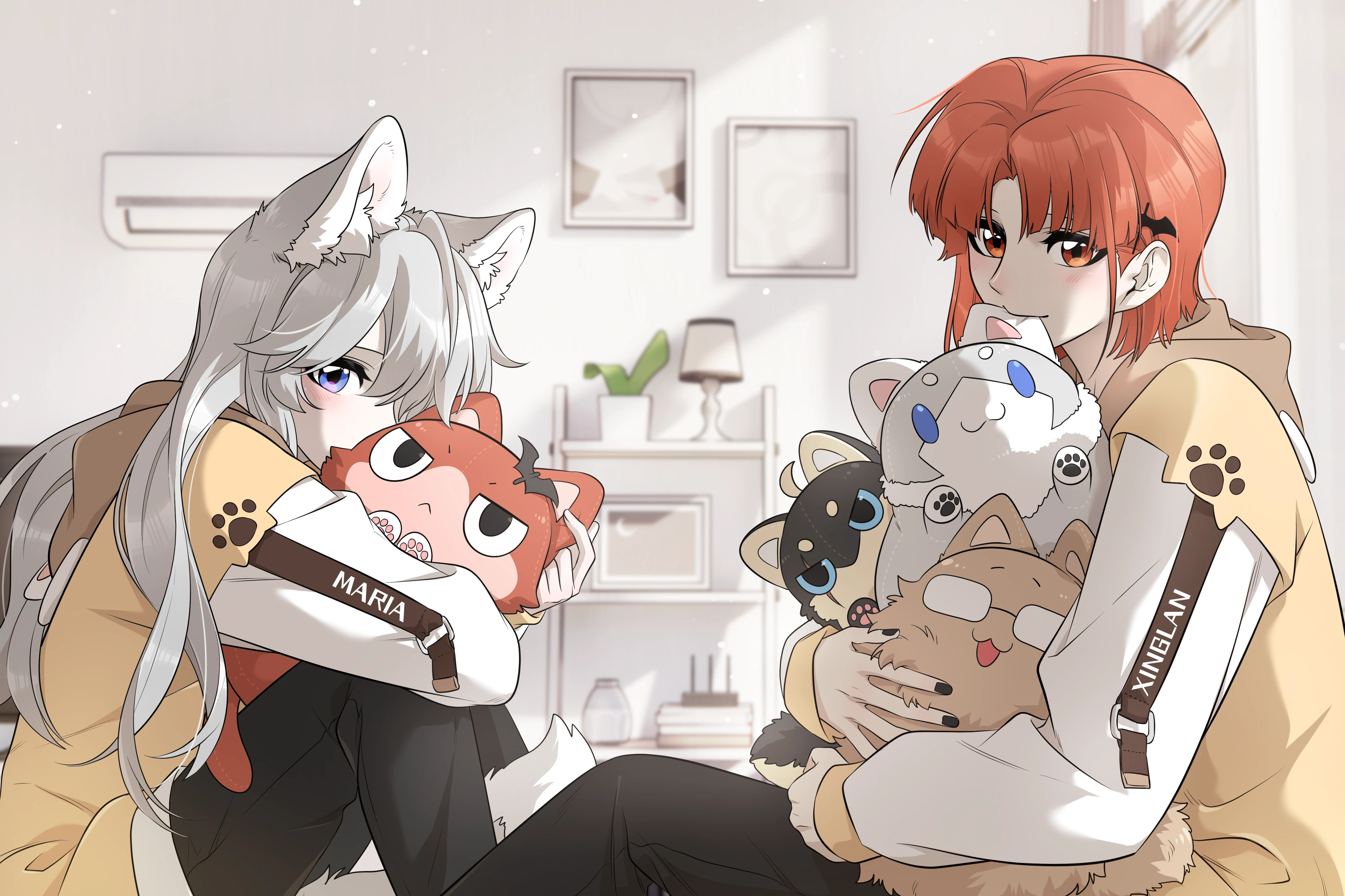 Maria and Xing Lan in matching hoodies, each hugging an armful of plush toys